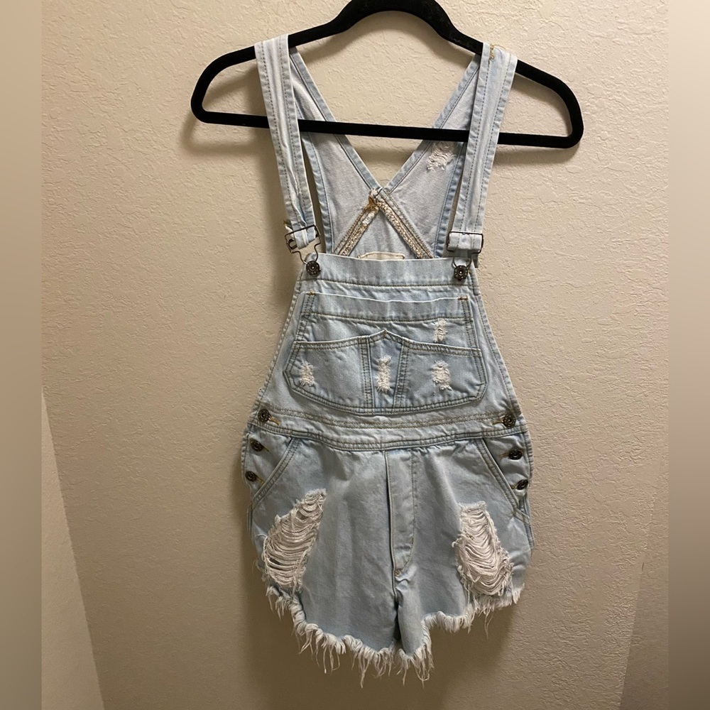 Carmar distressed light blue short overalls.
